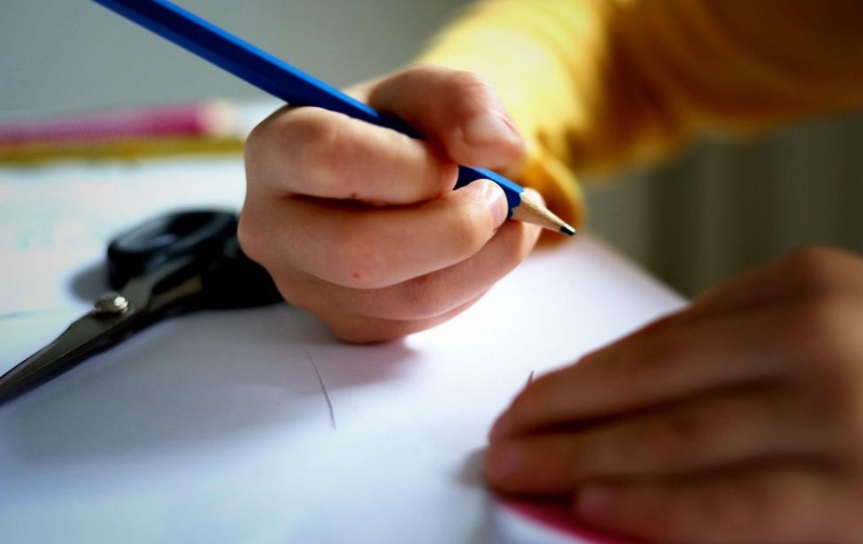 Kind hält Bleistift in der Hand