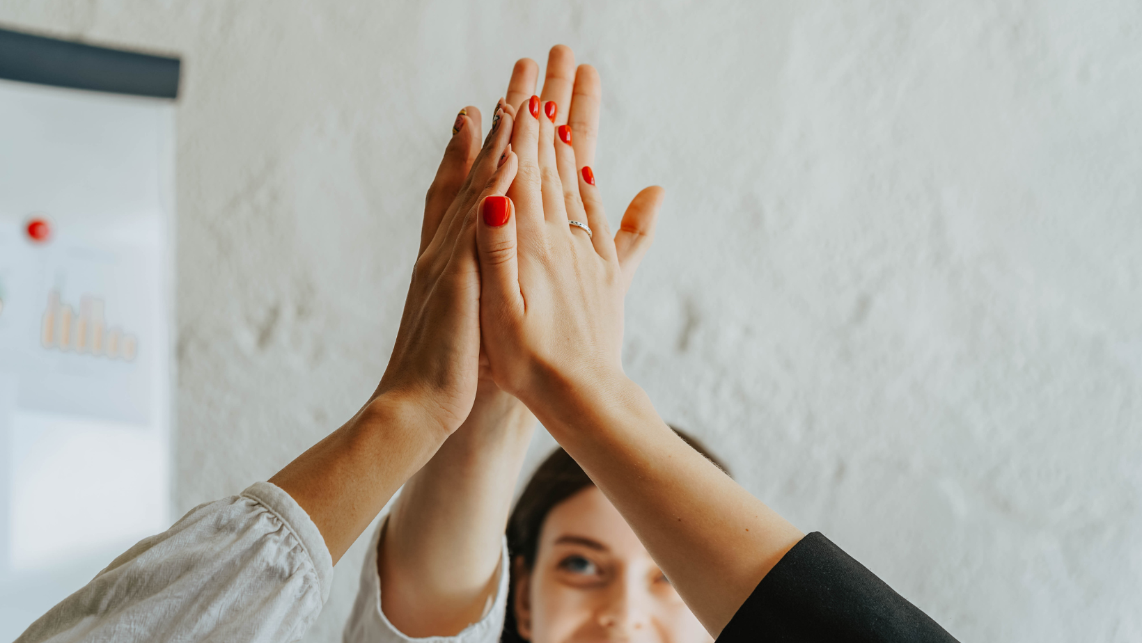 Fotografie von drei zusammengeschlagenen Händen